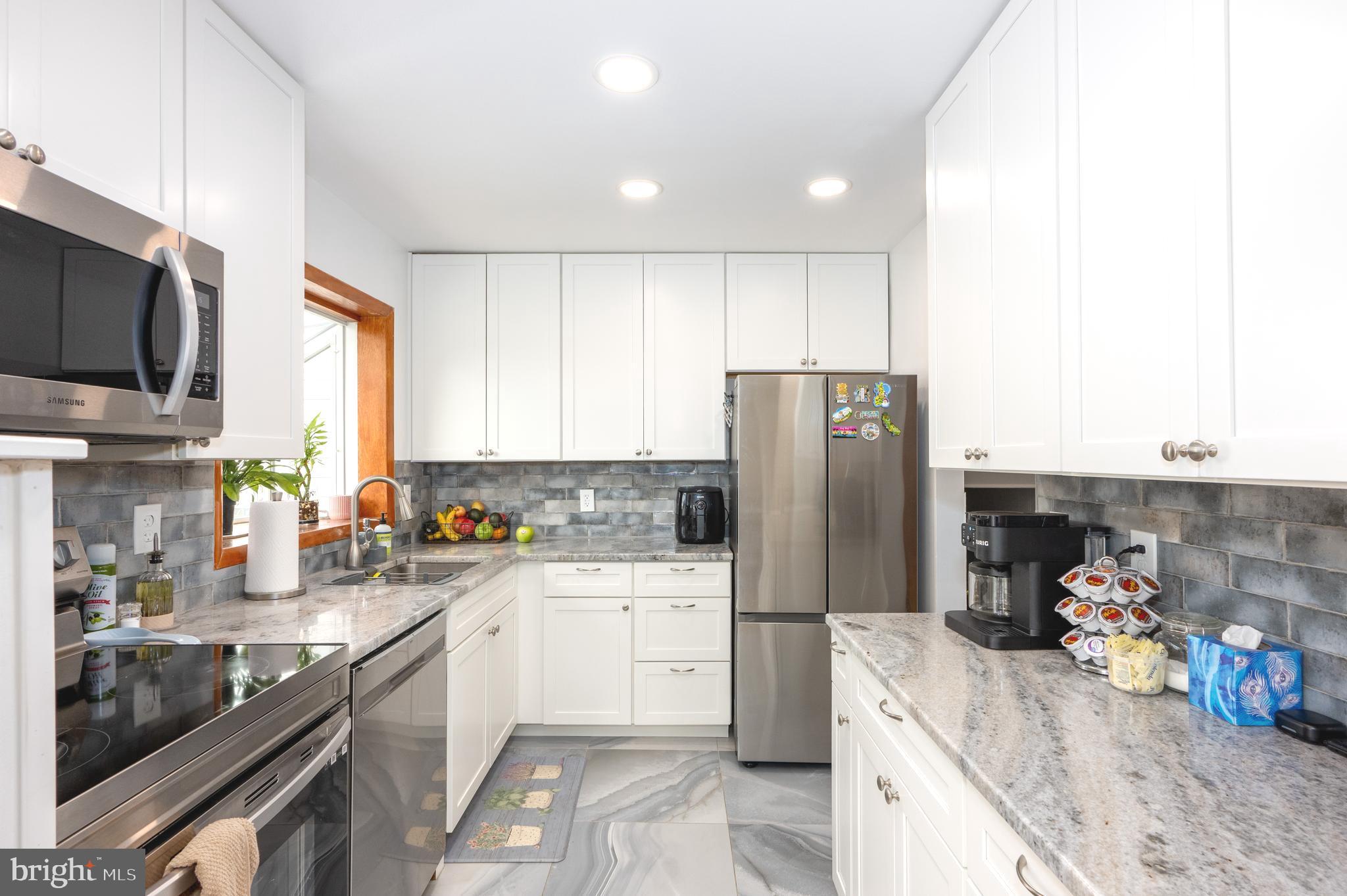 458 Roberts Way Aberdeen, MD 21001 - Photo 6 of 22 a kitchen with a sink a refrigerator and a stove top oven