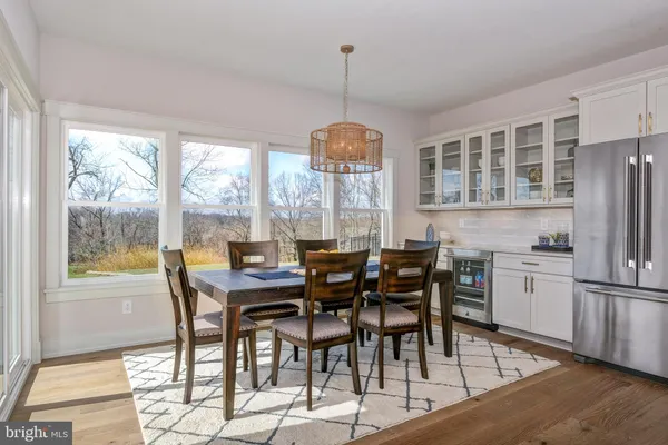a view of a dining room with furniture large window and wooden floor