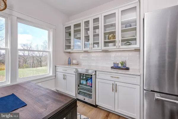 a kitchen with stainless steel appliances granite countertop a stove and a white cabinets