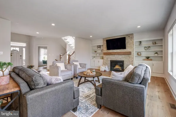 a living room with furniture a fireplace and a flat screen tv