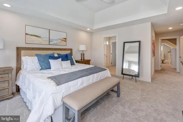 a bedroom with a bed and a mirror