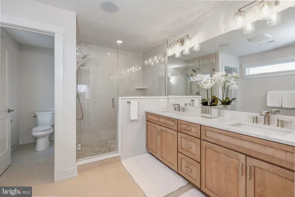 a spacious bathroom with a double vanity sink mirror and toilet