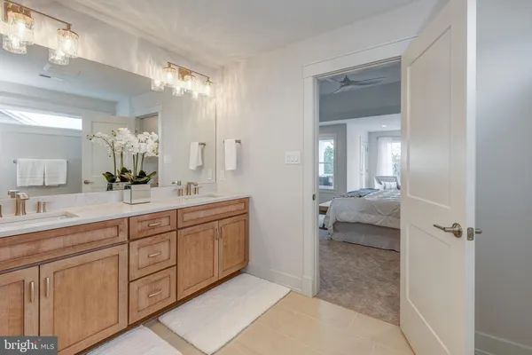 a spacious bathroom with a granite countertop sink mirror and a