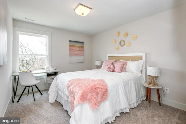 a bedroom with a bed and a table