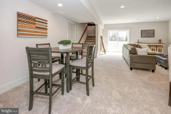 a dining room with furniture and a wooden floor