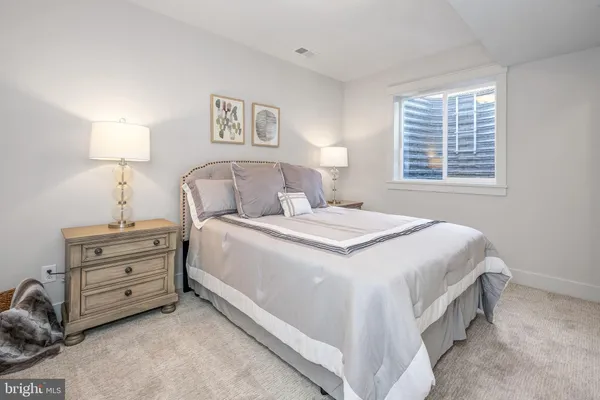 a bedroom with a bed and a night stand