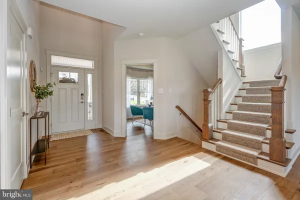 a view of an entryway with wooden floor and a livingroom view