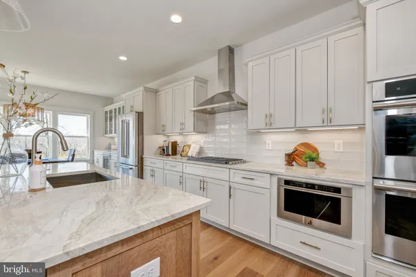 a kitchen with granite countertop a white cabinets and white appliances