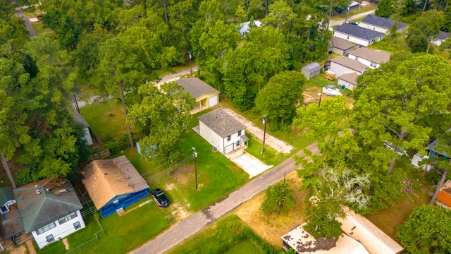 an aerial view of a house with a yard and lake view