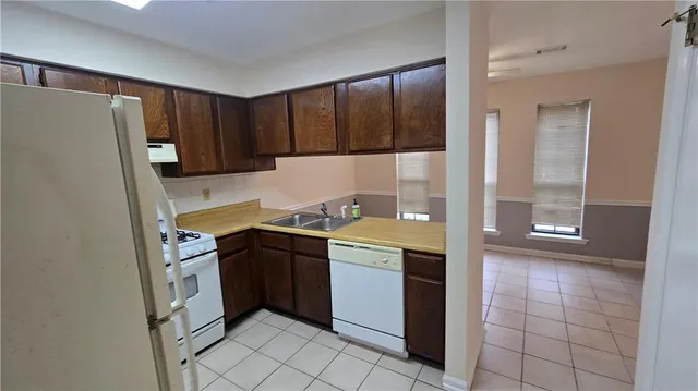 a kitchen with a stove a refrigerator and a sink