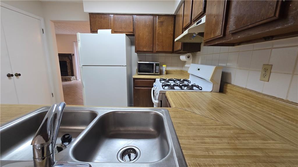 4722 Old Highgate Entry Stone Mountain, GA 30083 - Photo 12 of 31 a kitchen with a refrigerator and a stove top oven