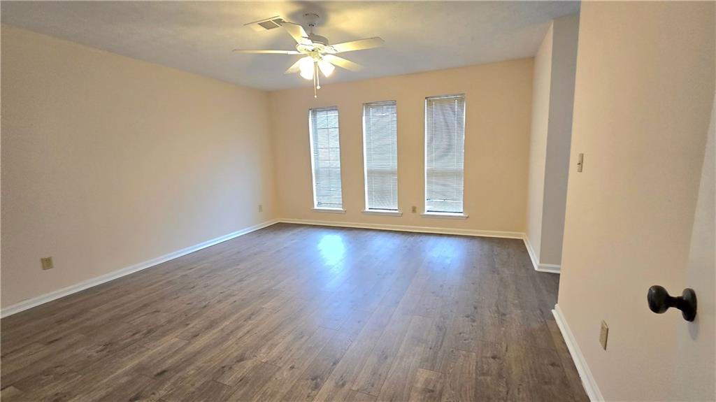 4722 Old Highgate Entry Stone Mountain, GA 30083 - Photo 16 of 31 an empty room with wooden floor and windows
