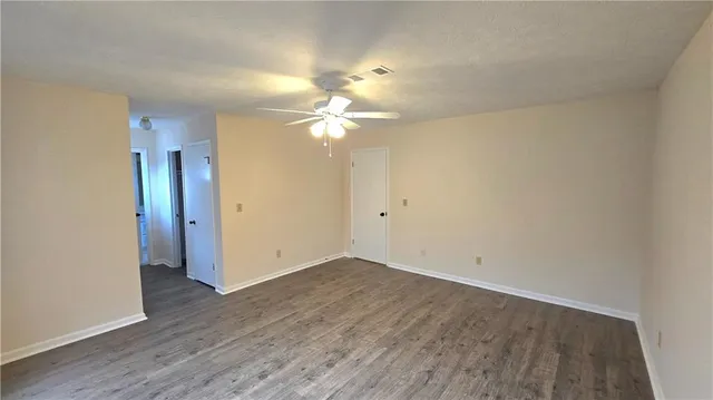 a view of a room with wooden floor