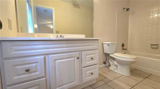 a bathroom with a toilet and a bath tub