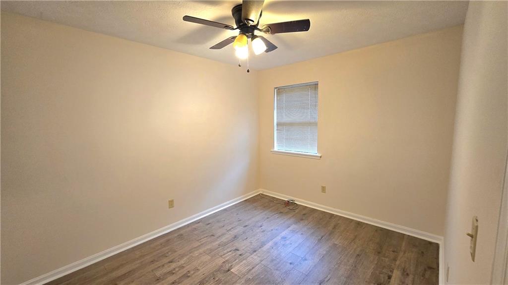 4722 Old Highgate Entry Stone Mountain, GA 30083 - Photo 26 of 31 an empty room with a window and a fan