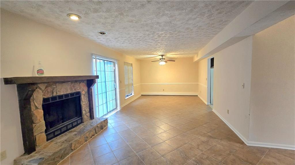 4722 Old Highgate Entry Stone Mountain, GA 30083 - Photo 5 of 31 a view of an empty room with a fireplace and a window