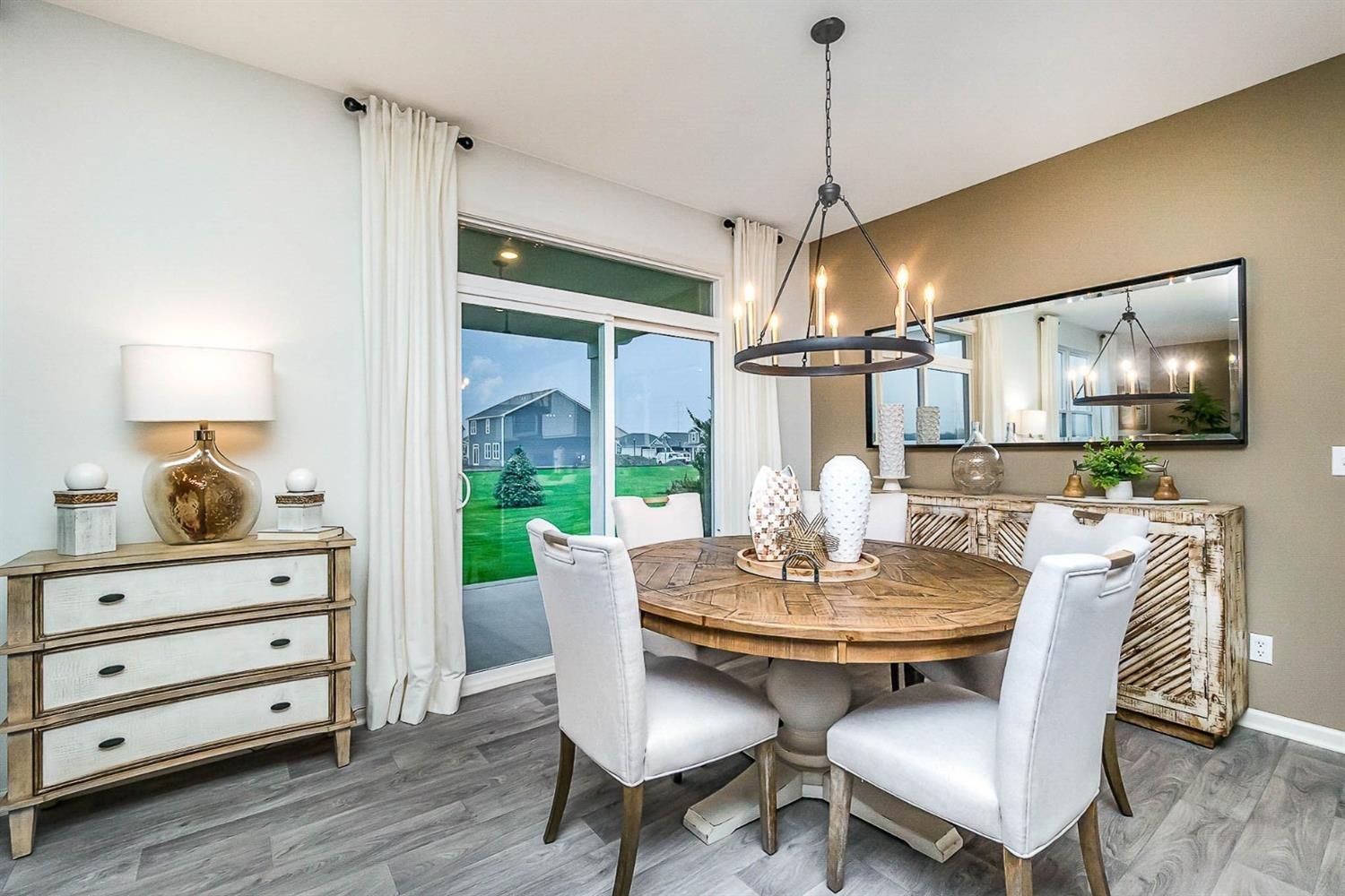 7718 West 103rd Street Crown Point, IN 46307 - Photo 11 of 47 a dining room with furniture a chandelier and wooden floor