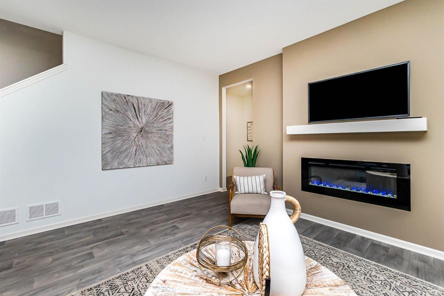 7718 West 103rd Street Crown Point, IN 46307 - Photo 14 of 47 a living room with furniture a flat screen tv and a fireplace