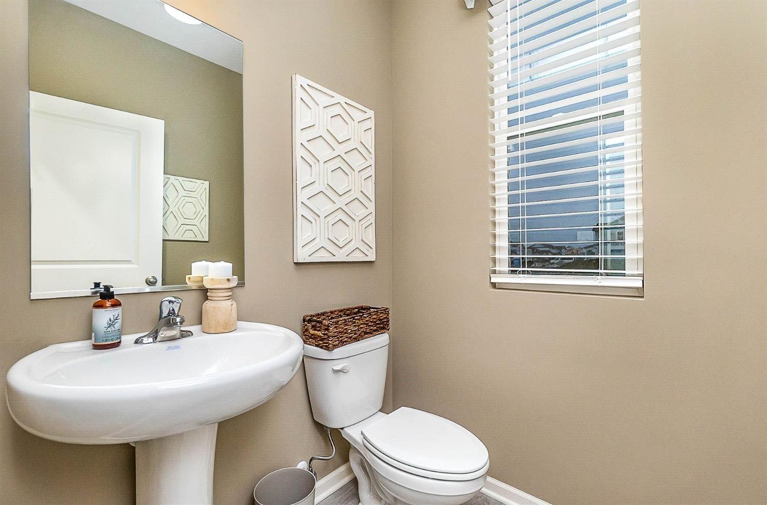 7718 West 103rd Street Crown Point, IN 46307 - Photo 15 of 47 a bathroom with a toilet sink and mirror