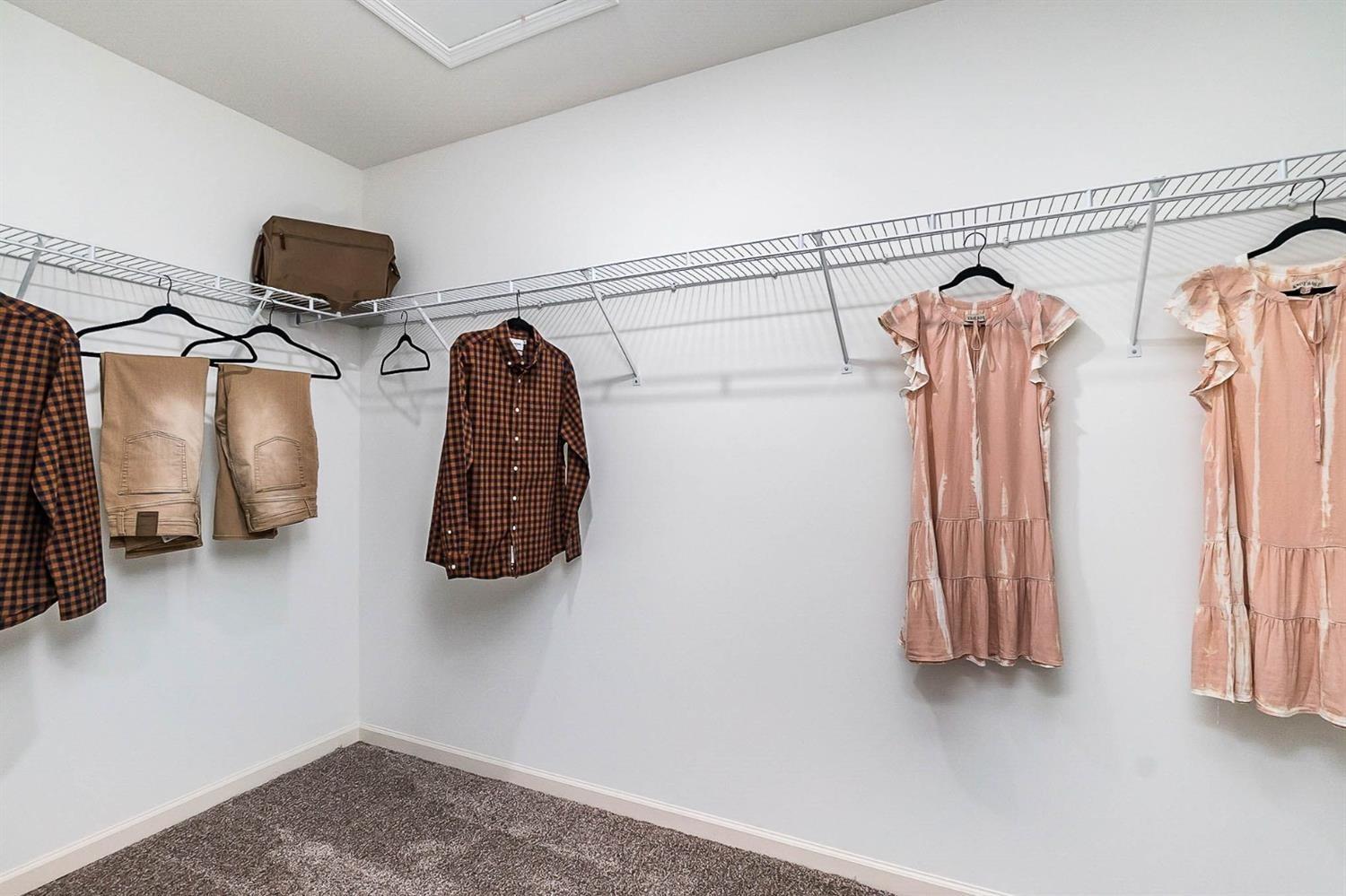 7718 West 103rd Street Crown Point, IN 46307 - Photo 23 of 47 a view of walk in closet with clothes and shoes