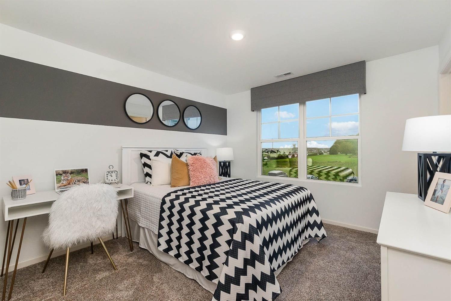 7718 West 103rd Street Crown Point, IN 46307 - Photo 24 of 47 a bedroom with a bed and a table in it with window