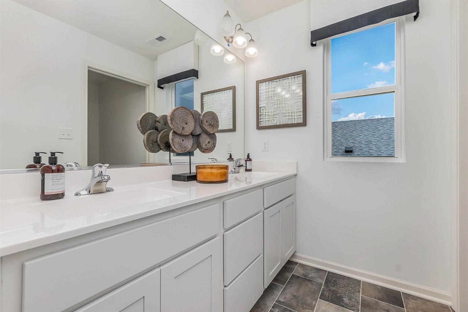 7718 West 103rd Street Crown Point, IN 46307 - Photo 26 of 47 a bathroom with a sink mirror and vanity