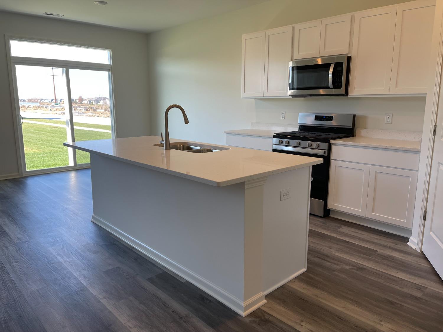 7718 West 103rd Street Crown Point, IN 46307 - Photo 34 of 47 a kitchen with a sink and a stove top oven