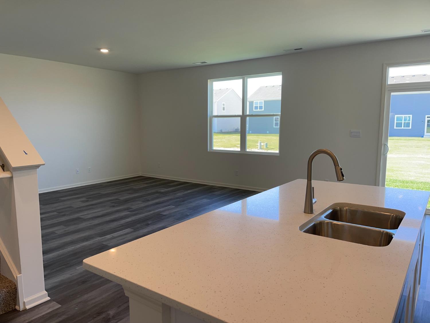 7718 West 103rd Street Crown Point, IN 46307 - Photo 35 of 47 a close view of a sink and dishwasher with wooden floor