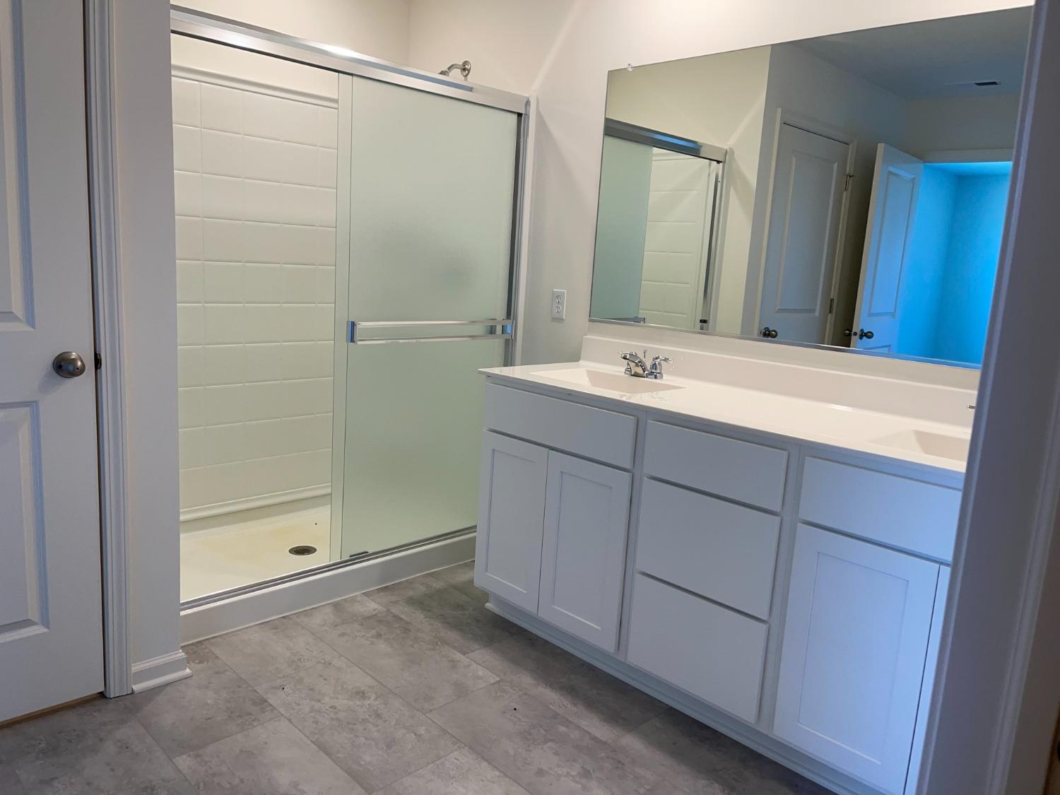 7718 West 103rd Street Crown Point, IN 46307 - Photo 37 of 47 a bathroom with a double vanity sink and mirror
