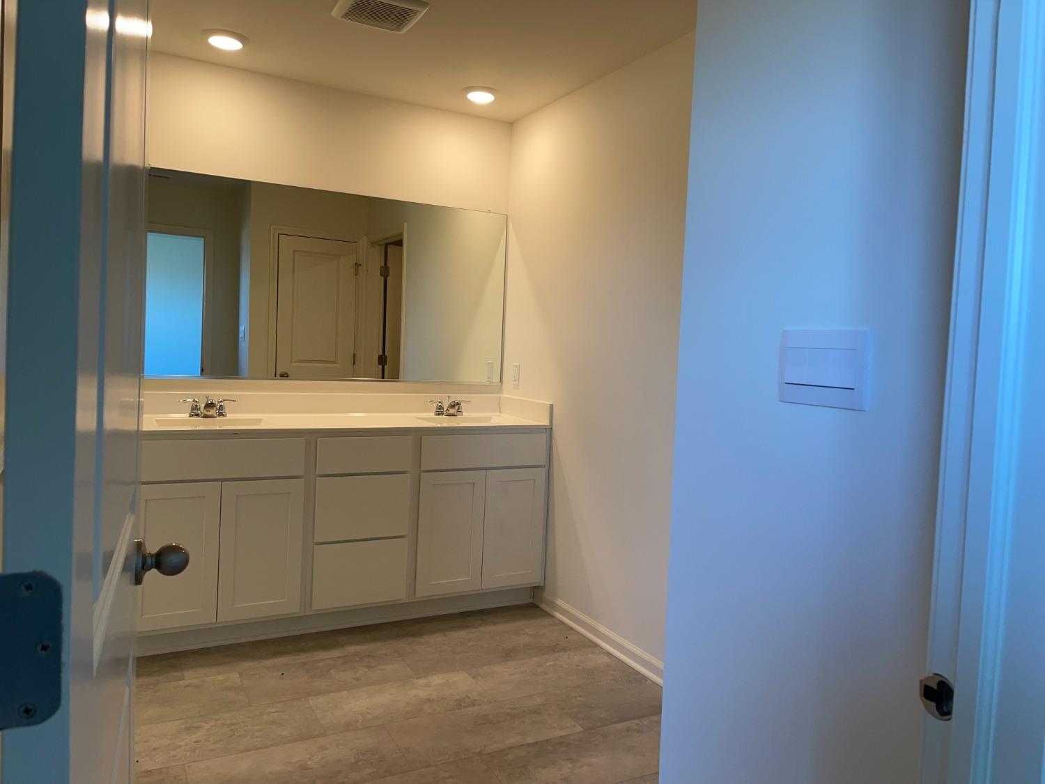 7718 West 103rd Street Crown Point, IN 46307 - Photo 38 of 47 a bathroom with a sink and a mirror