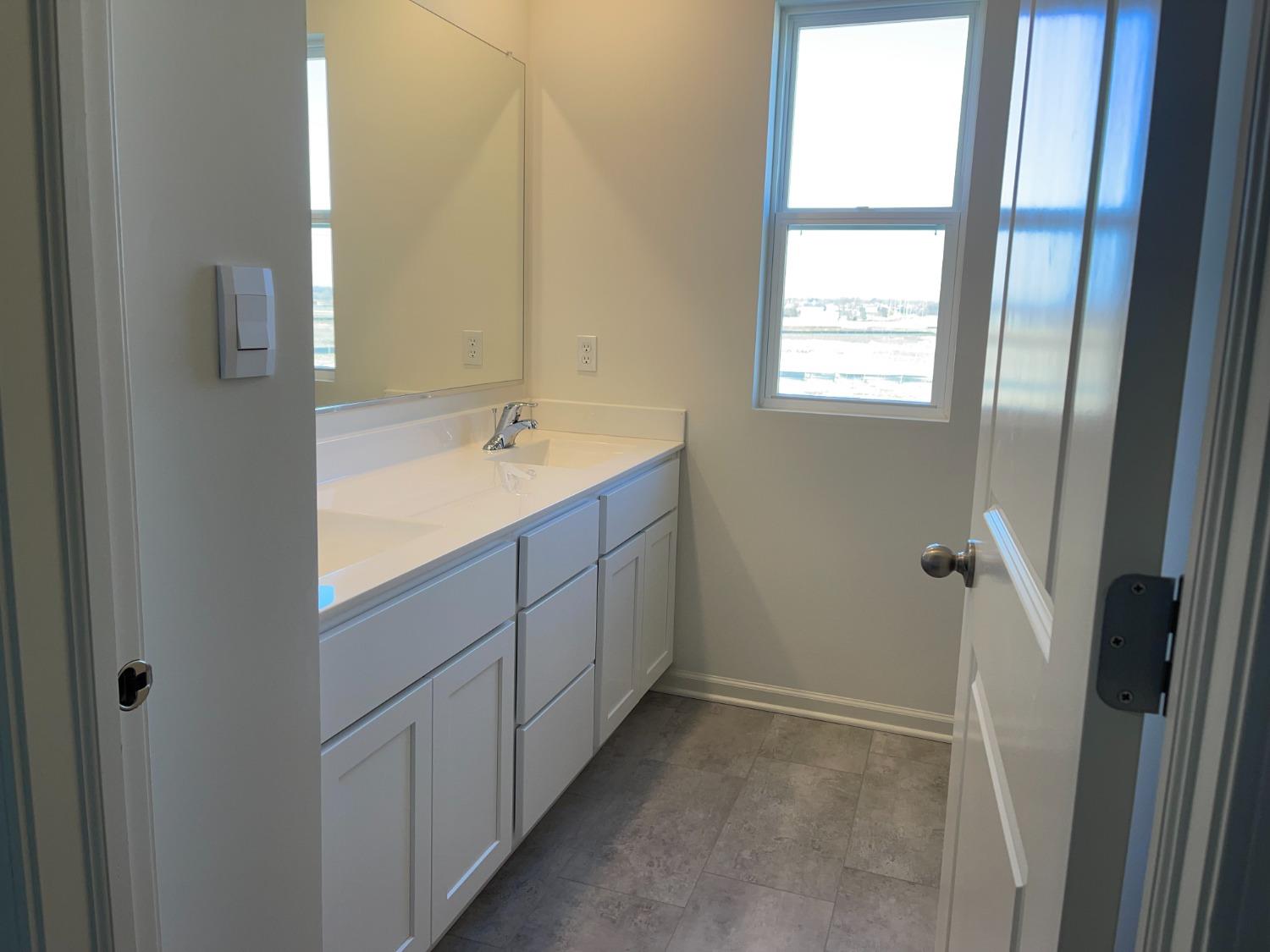 7718 West 103rd Street Crown Point, IN 46307 - Photo 39 of 47 a bathroom with a sink and a mirror