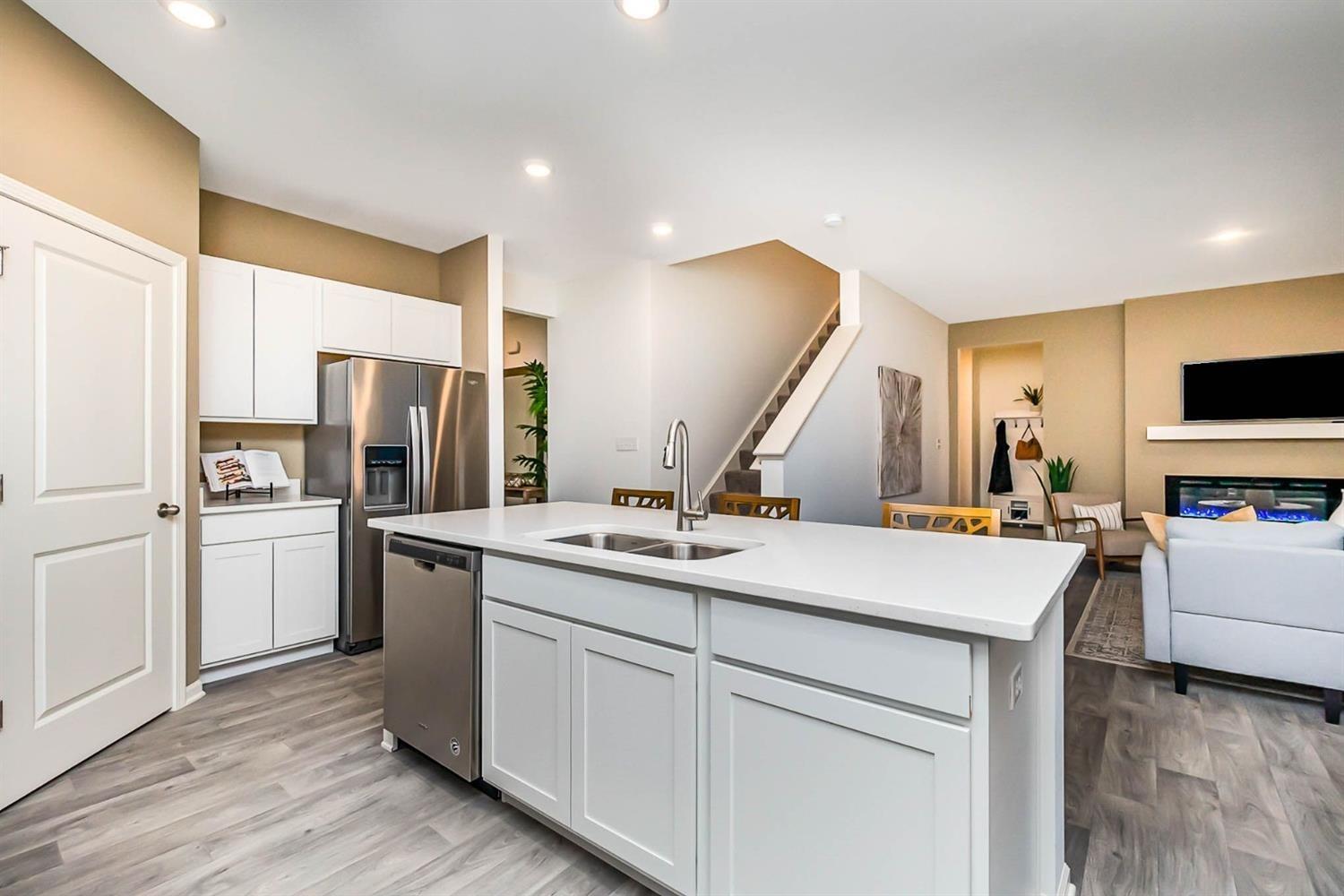 7718 West 103rd Street Crown Point, IN 46307 - Photo 8 of 47 a kitchen with a sink a stove a refrigerator and white cabinets