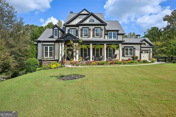 a front view of a house with a yard table and chairs