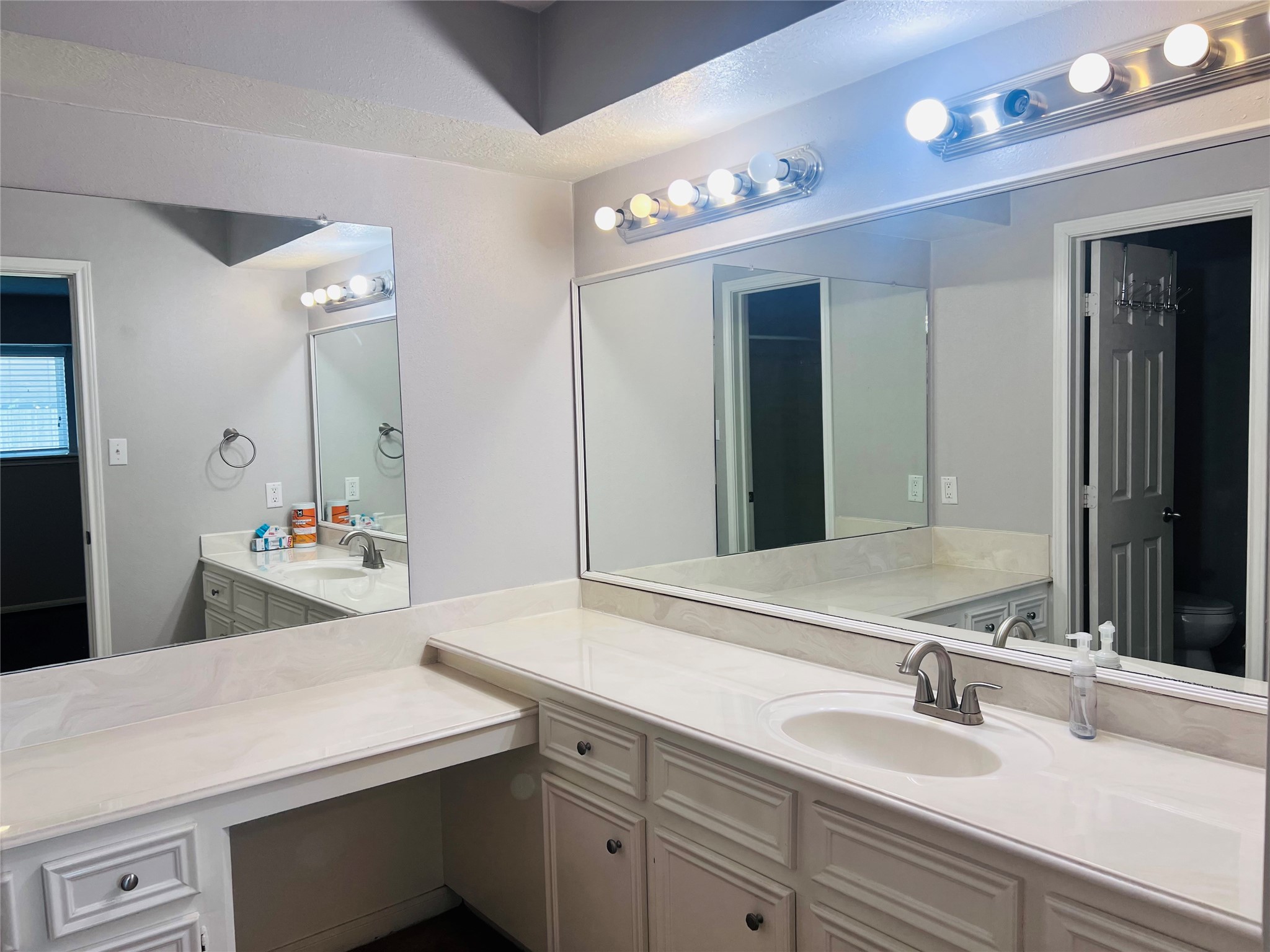 902 Hidden Canyon Road Katy, TX 77450 - Photo 11 of 20 This spacious primary bathroom features a large vanity with ample countertop space, dual sink setup, and well-lit mirrors. The neutral color palette offers a fresh and clean look.