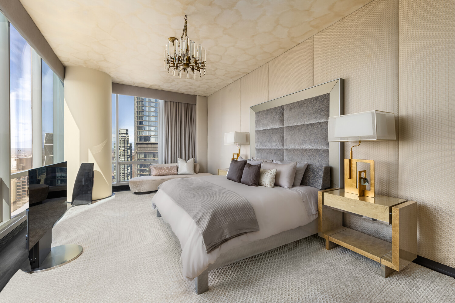 157 West 57th Street, Unit 52/53B Manhattan, NY 10019 - Photo 14 of 20 a bedroom with a bed and a chandelier