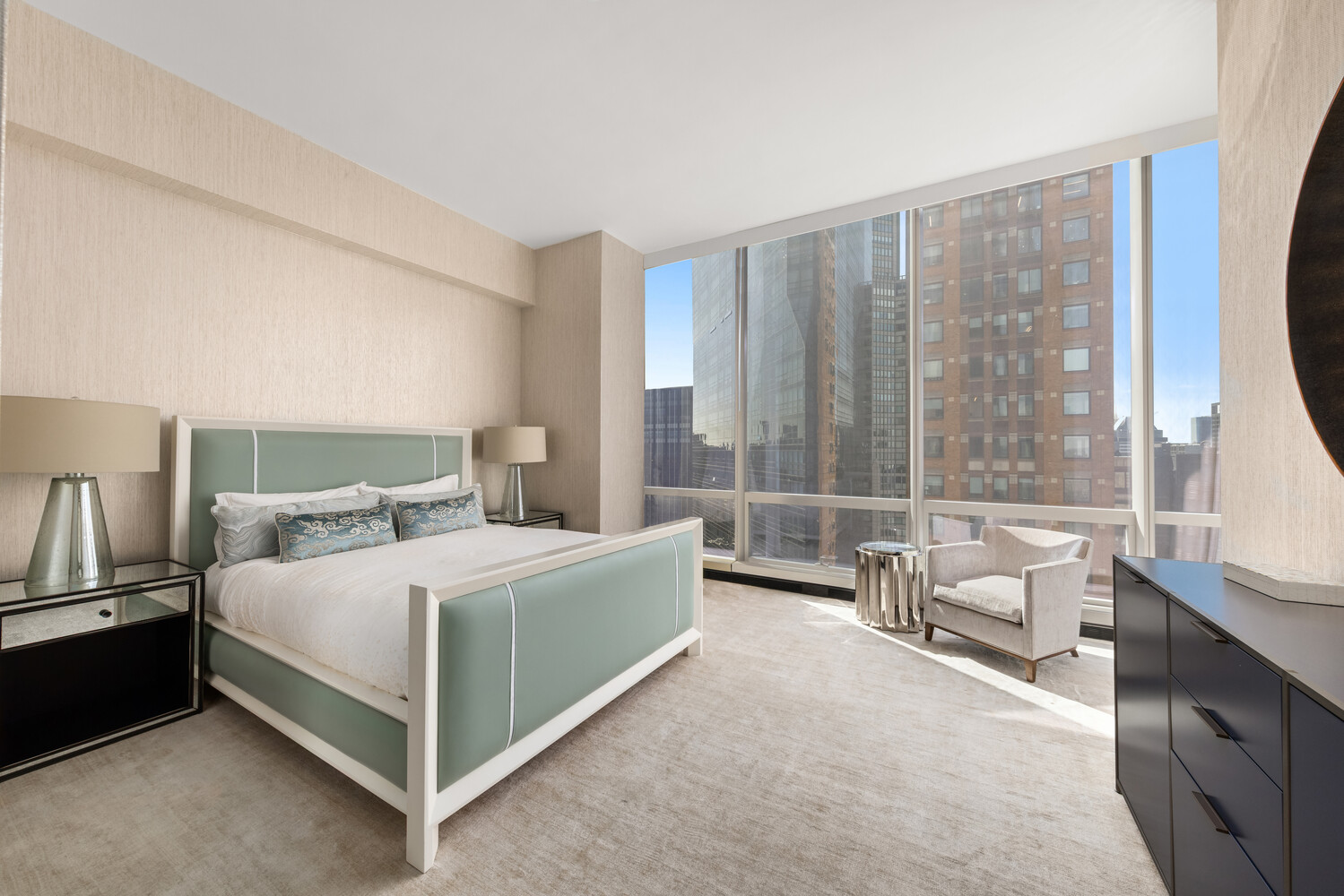 157 West 57th Street, Unit 52/53B Manhattan, NY 10019 - Photo 16 of 20 a bedroom with a bed and large window