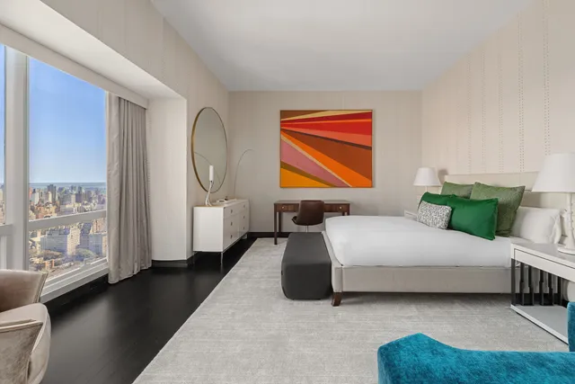 a bedroom with a bed couch and a window