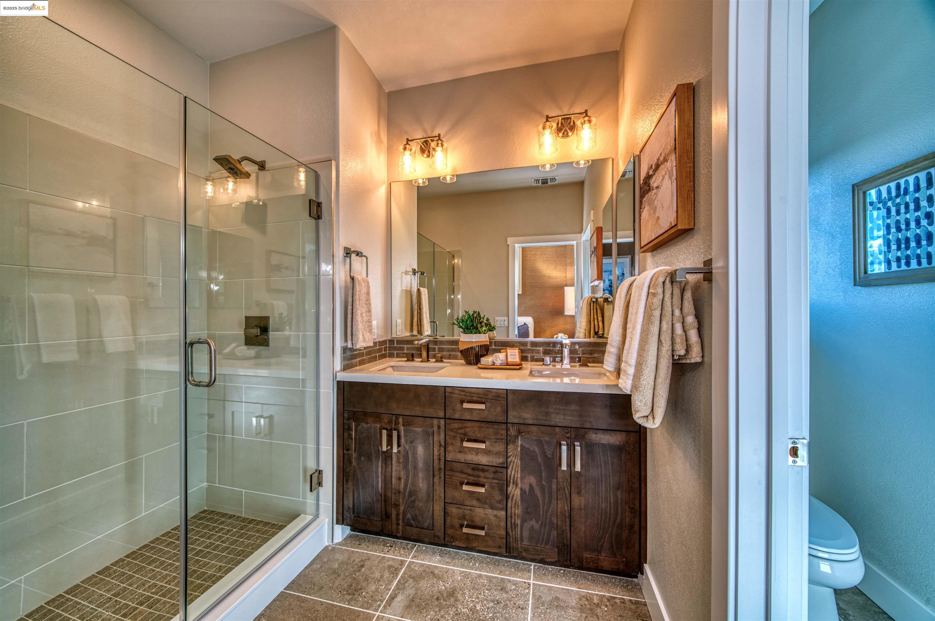 28949 Parkridge Loop, Unit 86 Hayward, CA 94544 - Photo 10 of 15 a bathroom with a granite countertop sink a toilet and shower