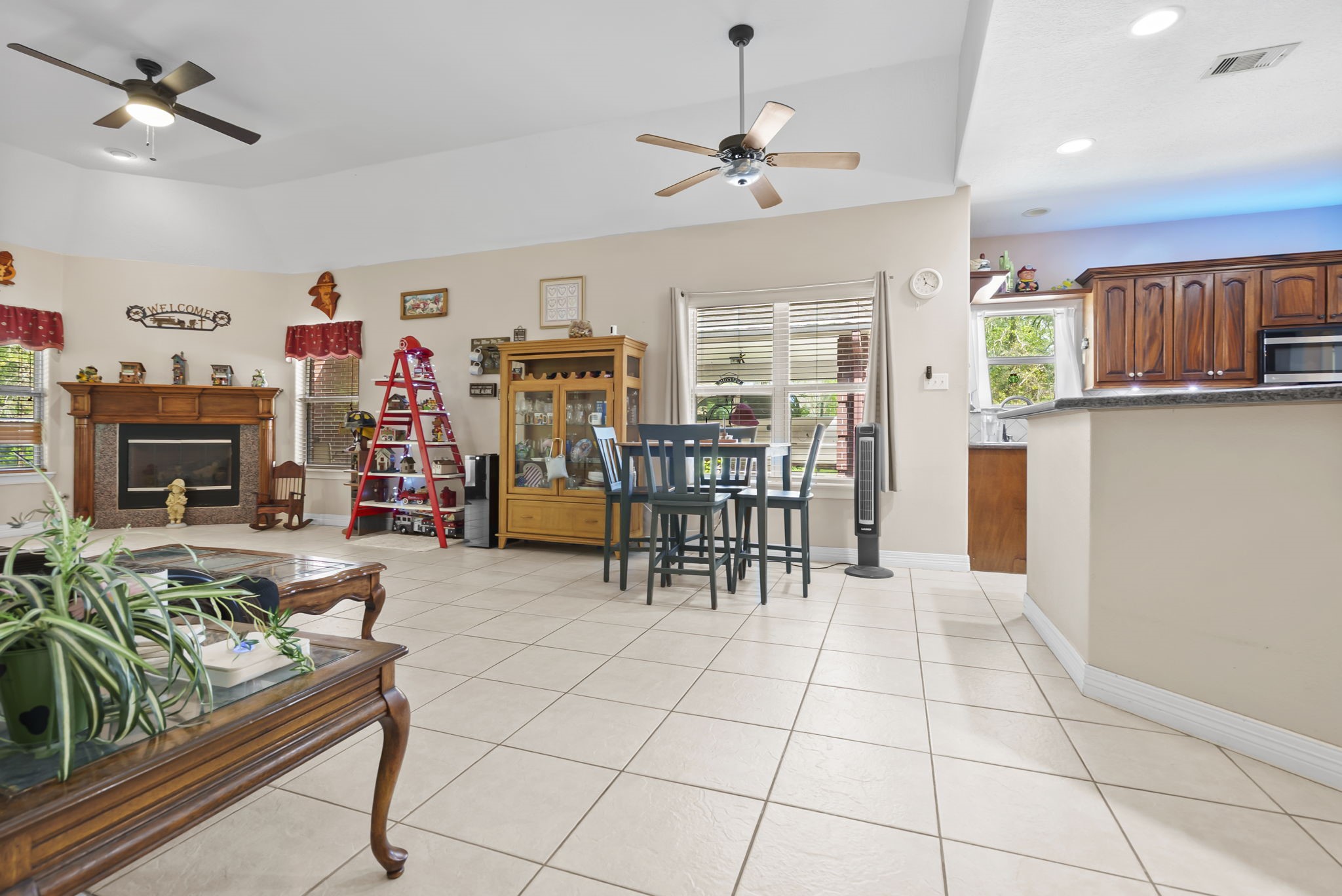 15524 Jim Branch Road Dayton, TX 77535 - Photo 26 of 40 a living room with furniture a dining table and a fireplace
