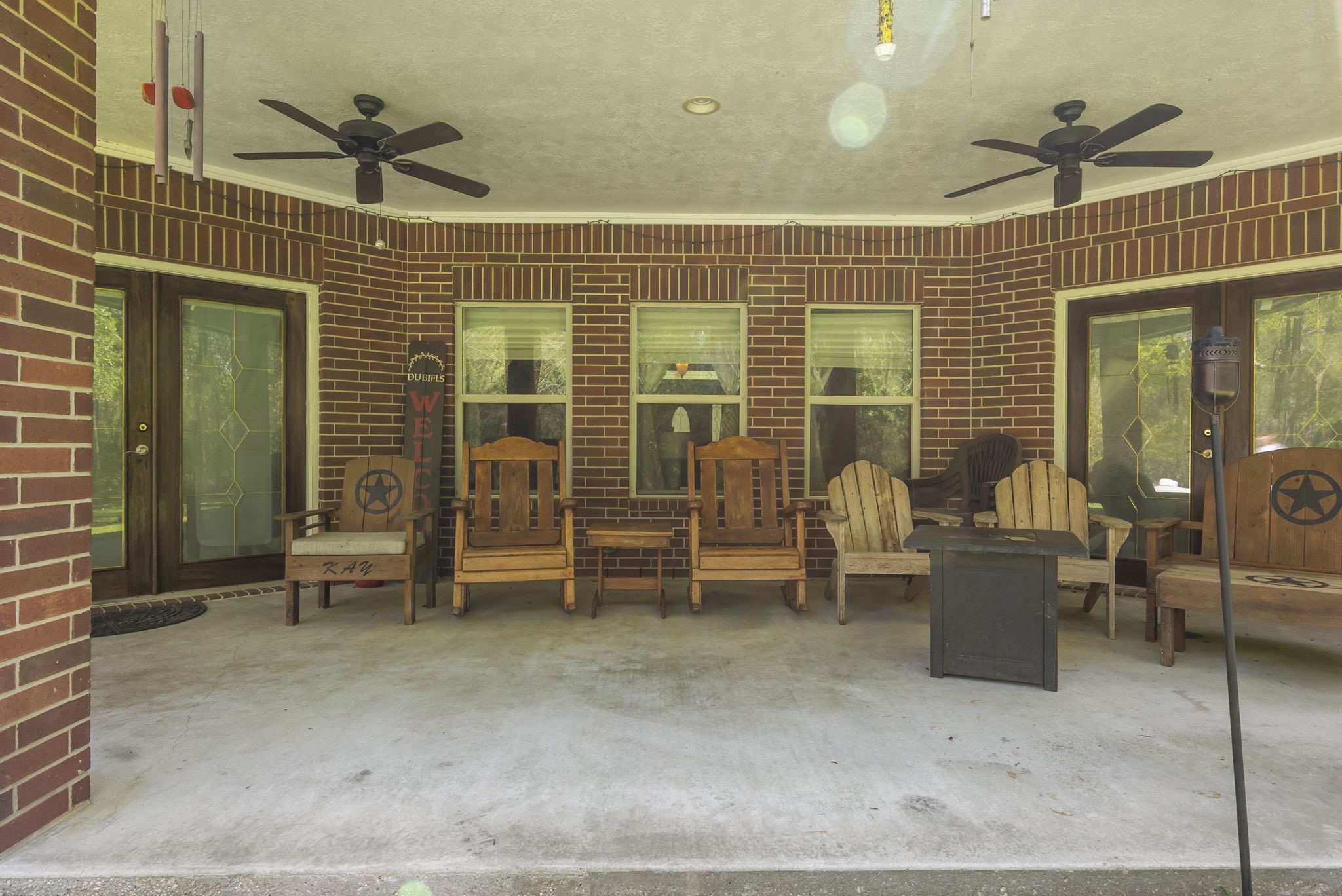 15524 Jim Branch Road Dayton, TX 77535 - Photo 30 of 40 Step outside to a peaceful patio overlooking mature trees, perfect for relaxing or enjoying your morning coffee