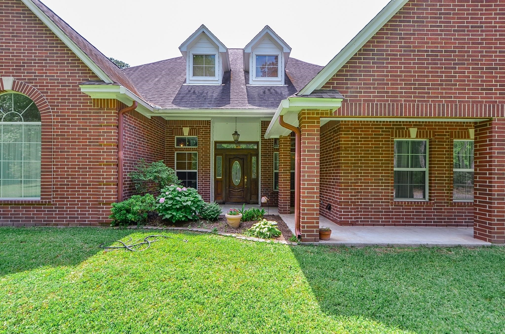 15524 Jim Branch Road Dayton, TX 77535 - Photo 3 of 40 a front view of a house with a yard