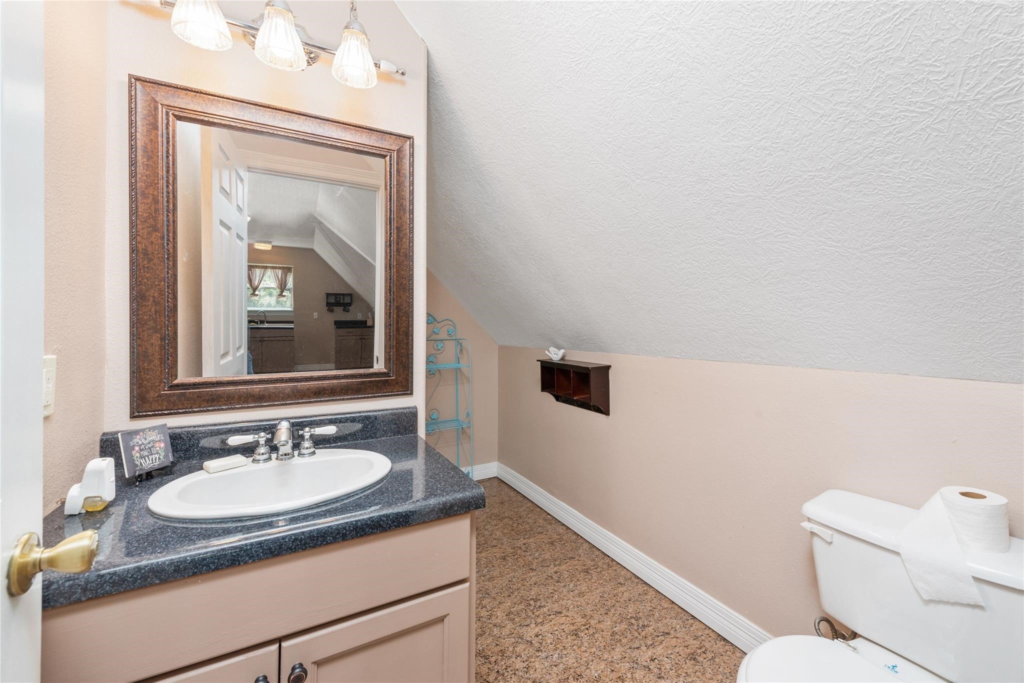 15524 Jim Branch Road Dayton, TX 77535 - Photo 33 of 40 a bathroom with a granite countertop sink a mirror and a toilet