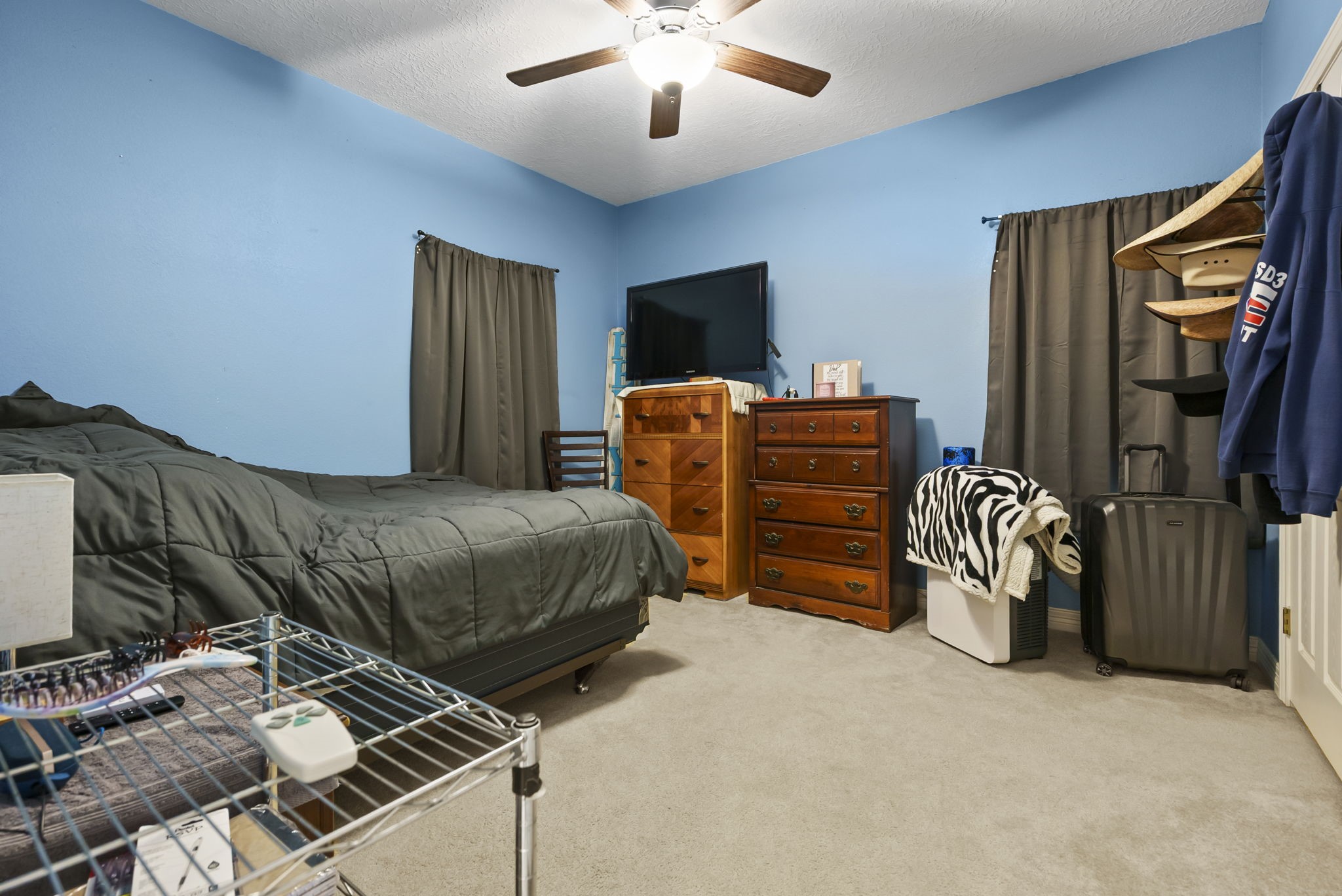 15524 Jim Branch Road Dayton, TX 77535 - Photo 10 of 40 a bedroom with a bed and a chandelier