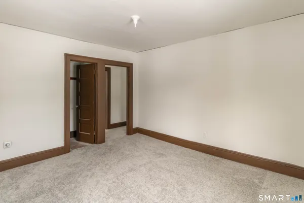 a view of an empty room and closet area