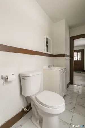 a white toilet sitting next to a bathroom sink