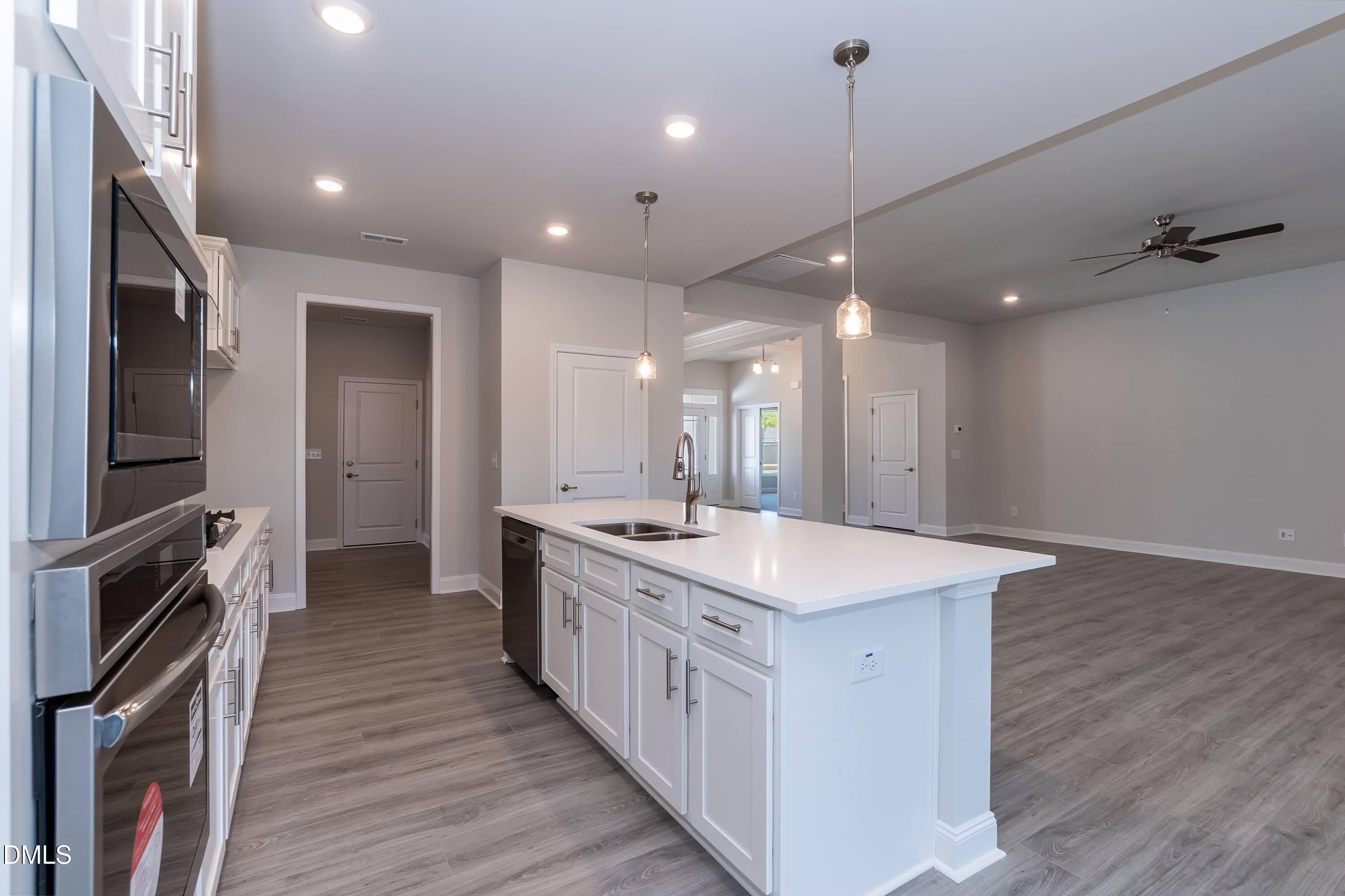 49 Galway Road Lillington, NC 27546 - Photo 11 of 39 a large kitchen with a stove sink and a refrigerator