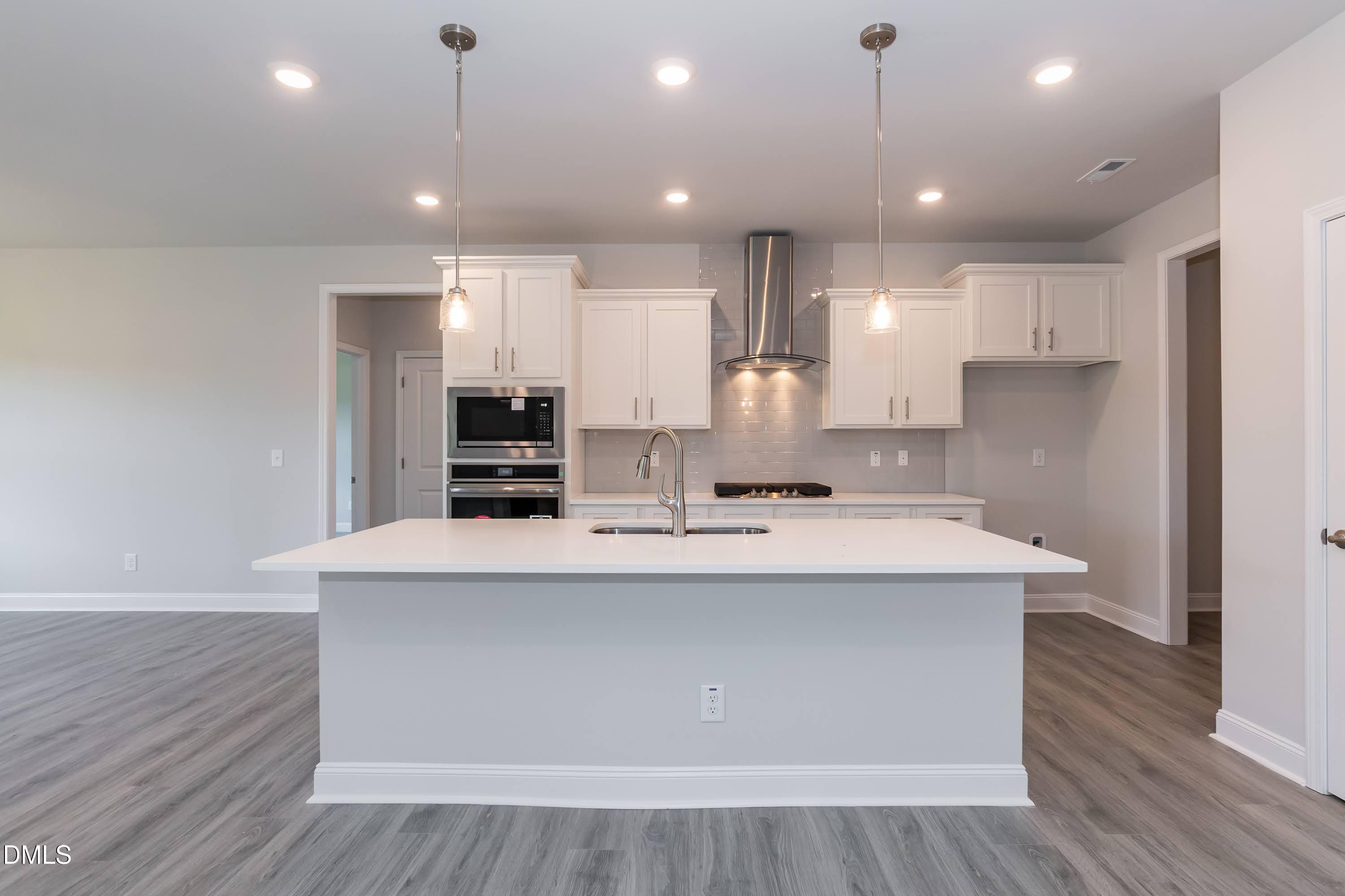 49 Galway Road Lillington, NC 27546 - Photo 12 of 39 a kitchen with kitchen island a sink stainless steel appliances and cabinets