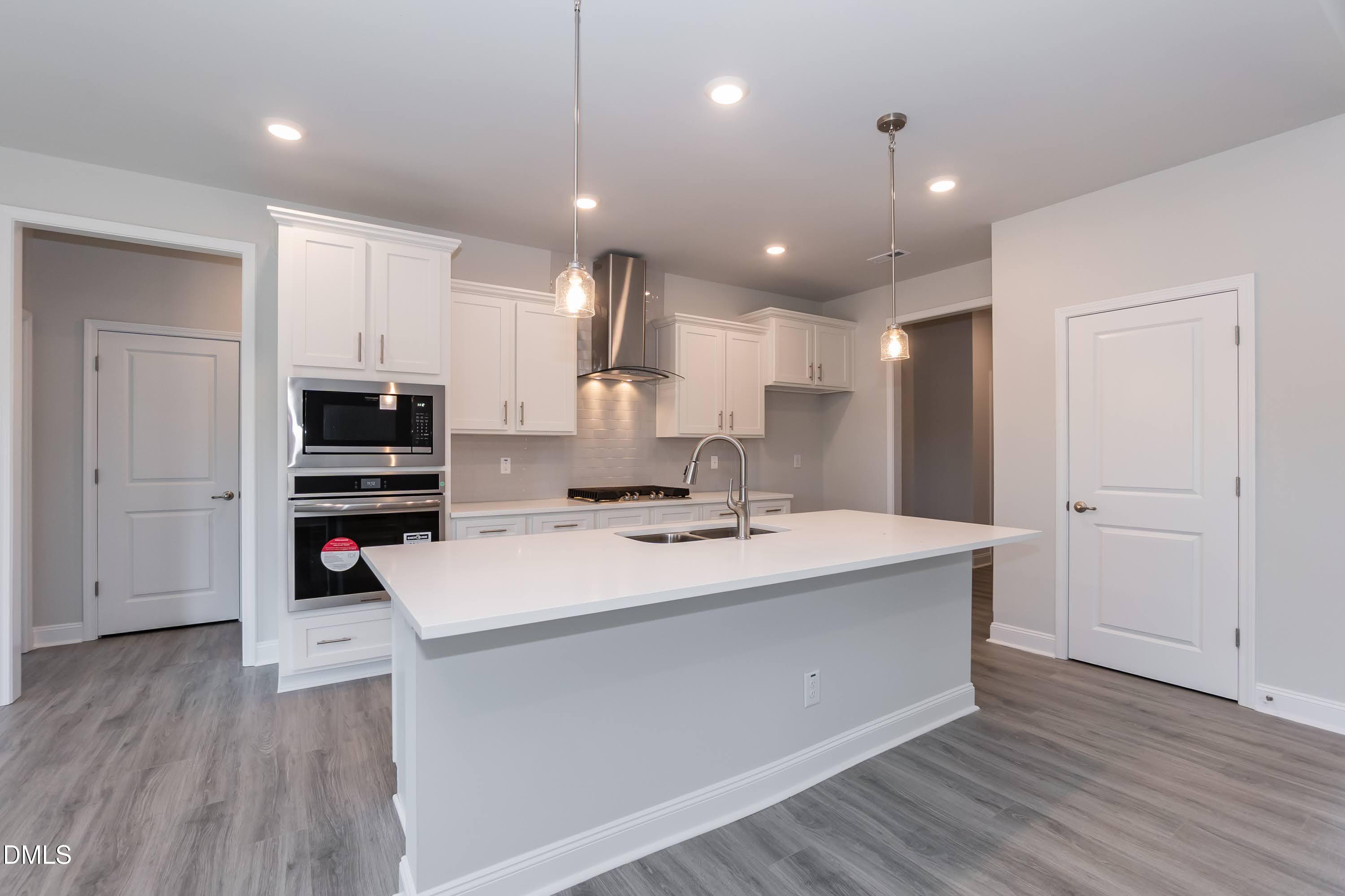 49 Galway Road Lillington, NC 27546 - Photo 13 of 39 a large kitchen with stainless steel appliances kitchen island a large counter top and a stove top oven