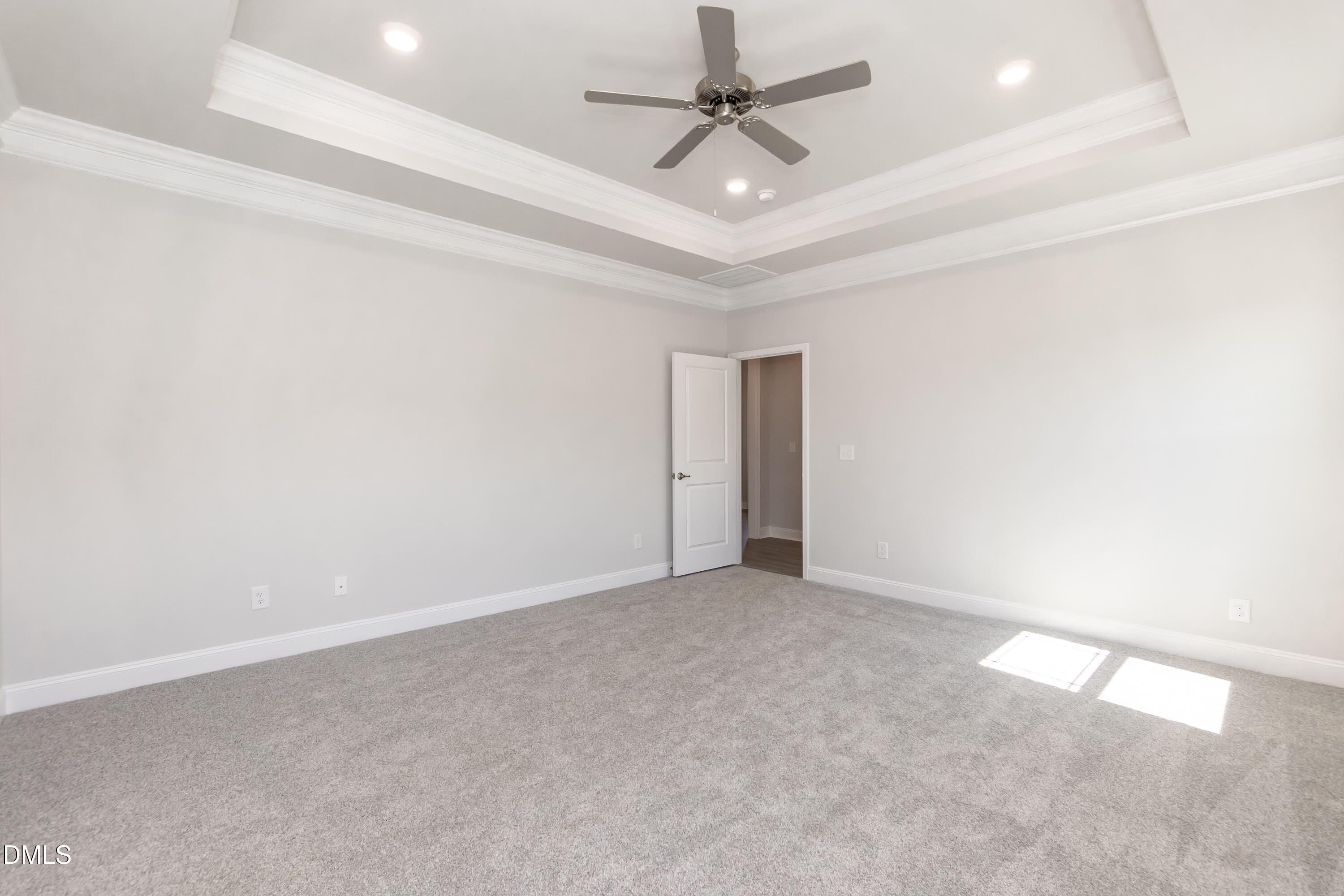 49 Galway Road Lillington, NC 27546 - Photo 22 of 39 an empty room with a ceiling fan and a window