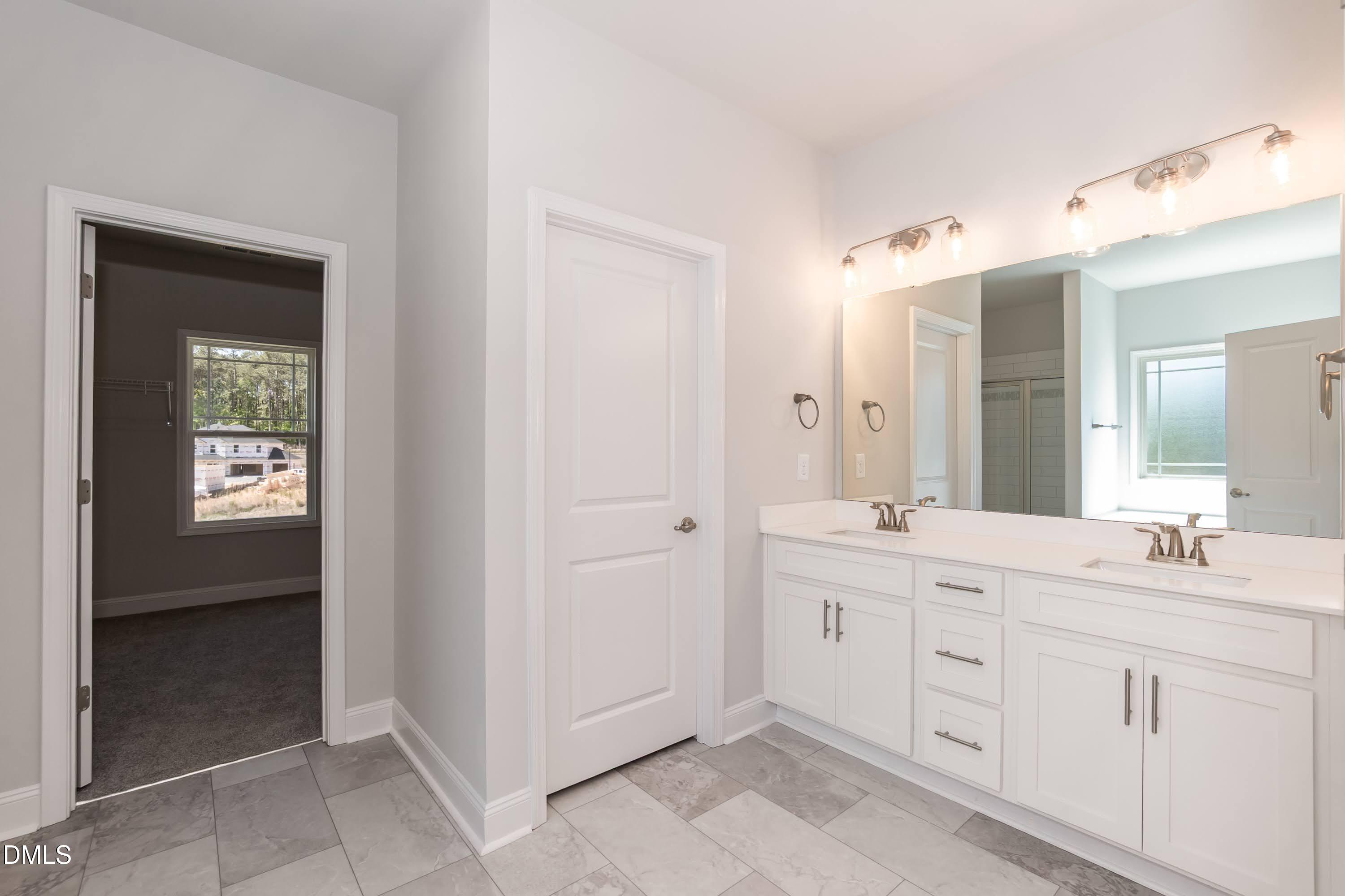 49 Galway Road Lillington, NC 27546 - Photo 24 of 39 a spacious bathroom with a double vanity sink a mirror and a